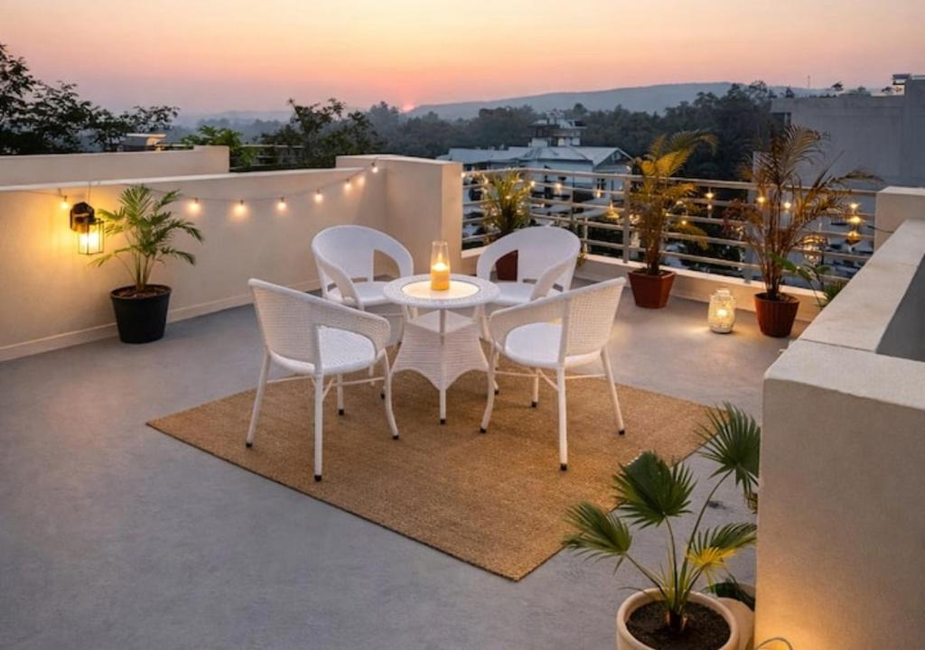 a patio with a table and chairs on a balcony at RADHA Homestay in Mathura