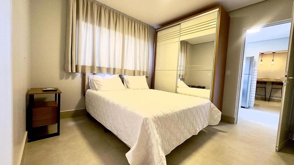 a bedroom with a white bed and a large window at Essenza Living in Formosa