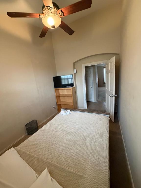 a bedroom with a ceiling fan and a bed at Goodyear Cul-de-sac Room 6 in Goodyear