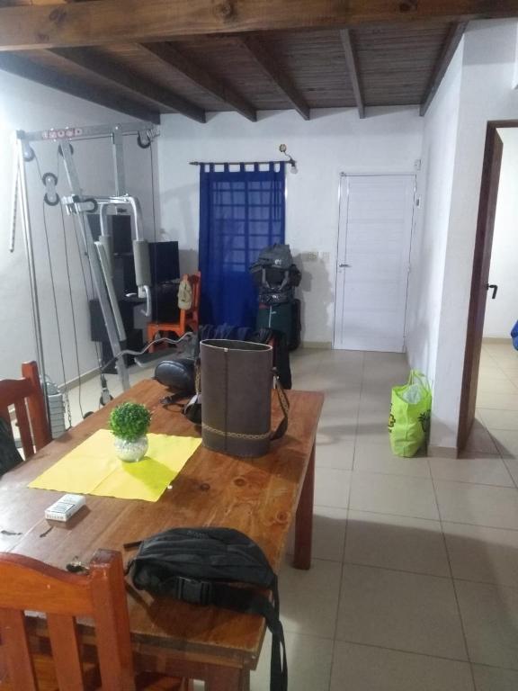a room with a wooden table and a gym at Moru in Mar del Tuyú