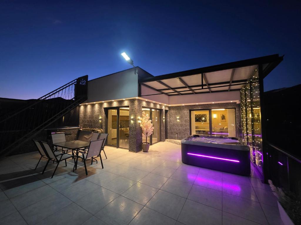 a house with a jacuzzi in the backyard at night at Villa Panorama View Brezovica in Brezovica