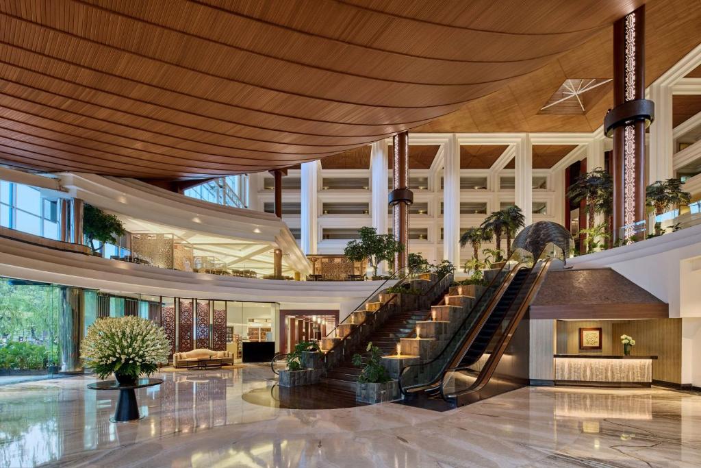 a lobby with a spiral staircase in a building at Gran Meliá Jakarta in Jakarta