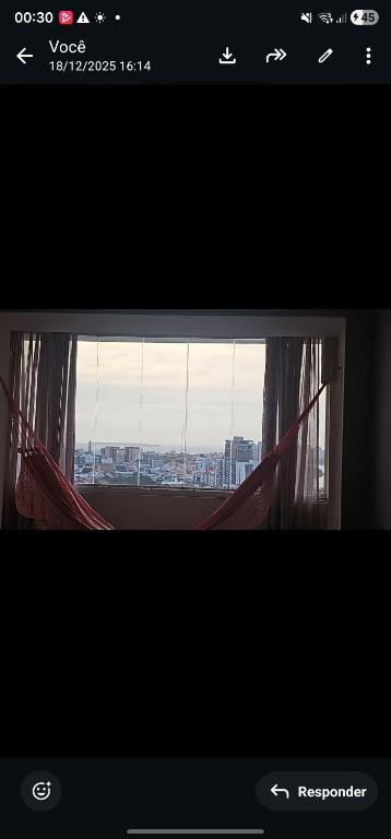 a window with a view of a city at Mom Blanc Flat Service in São Luís