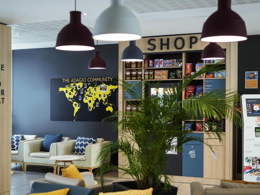 a store with chairs and a shop sign on the wall at Aparthotel Adagio Access Le Havre Les Docks in Le Havre
