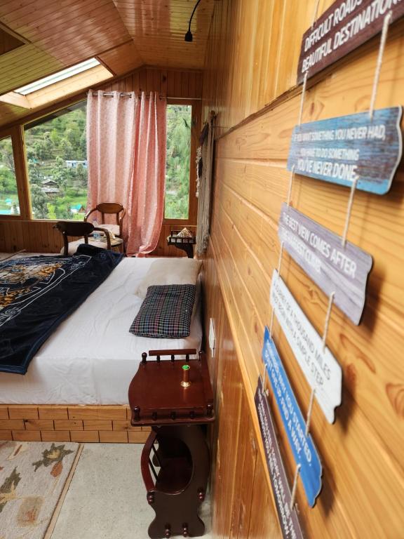 a room with a bed and signs on the wall at Avina Heaven in Banjār