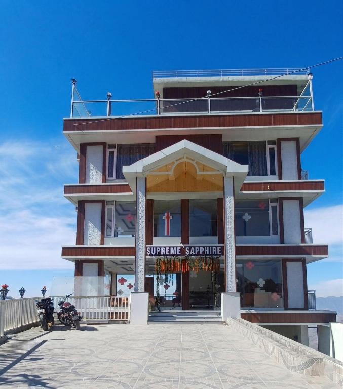 a building on the beach with motorcycles parked in front at Supreme Sapphire Kufri in Fagu