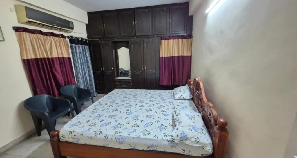 a bedroom with a bed in a room with curtains at Villa Dome Retreat in Kanchipuram