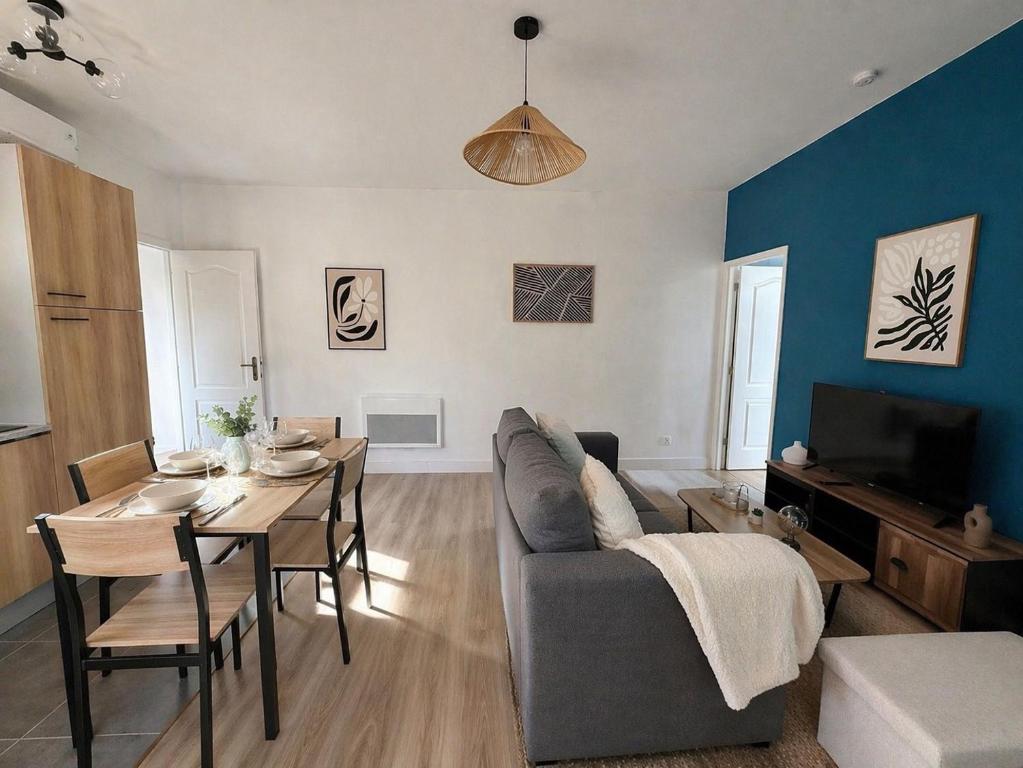 a living room with a couch and a table at Appartement Cosy Trelazé in Trélazé