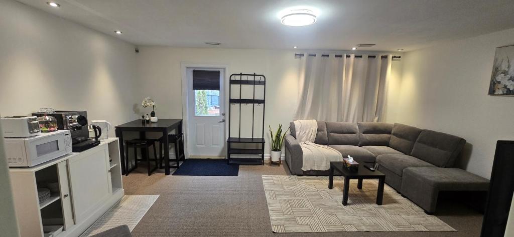 a living room with a couch and a table at Cozy Basement Suite in Lower Sackville