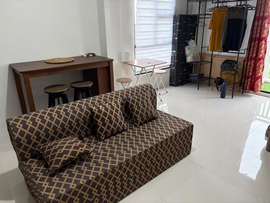a living room with a couch and a table at Studio condo oceanside - pools, gym, mini market in Dao