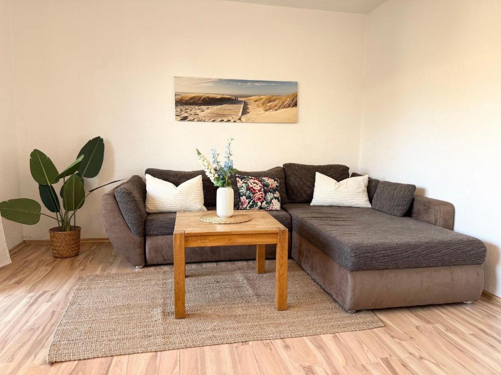 a living room with a couch and a table at Haus-Jenina-Ferienwohnung in Cuxhaven