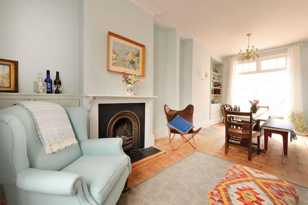 a living room with a couch and a fireplace at The Chocolate-Box * Aldeburgh in Aldeburgh