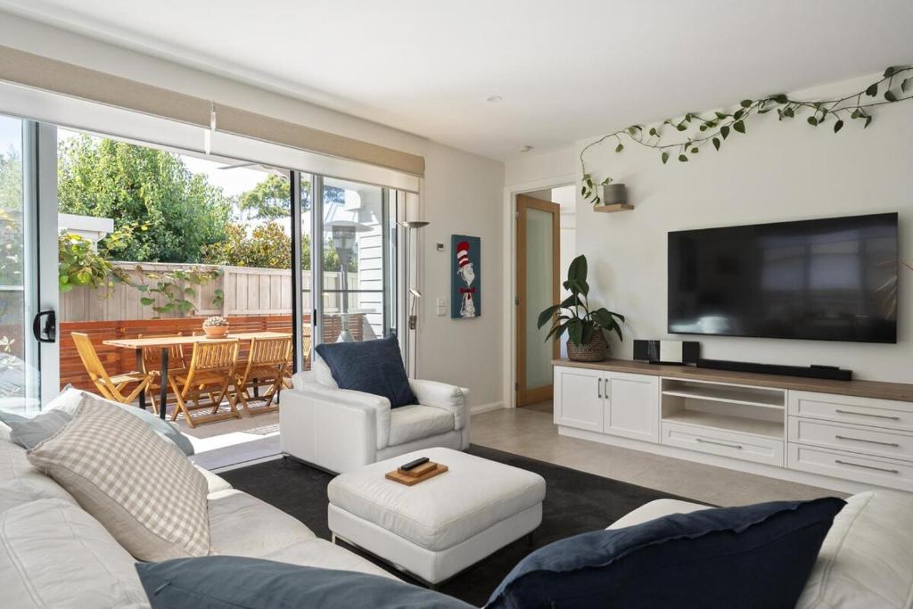 a living room with a white couch and a television at My Place, McCrae in McCrae
