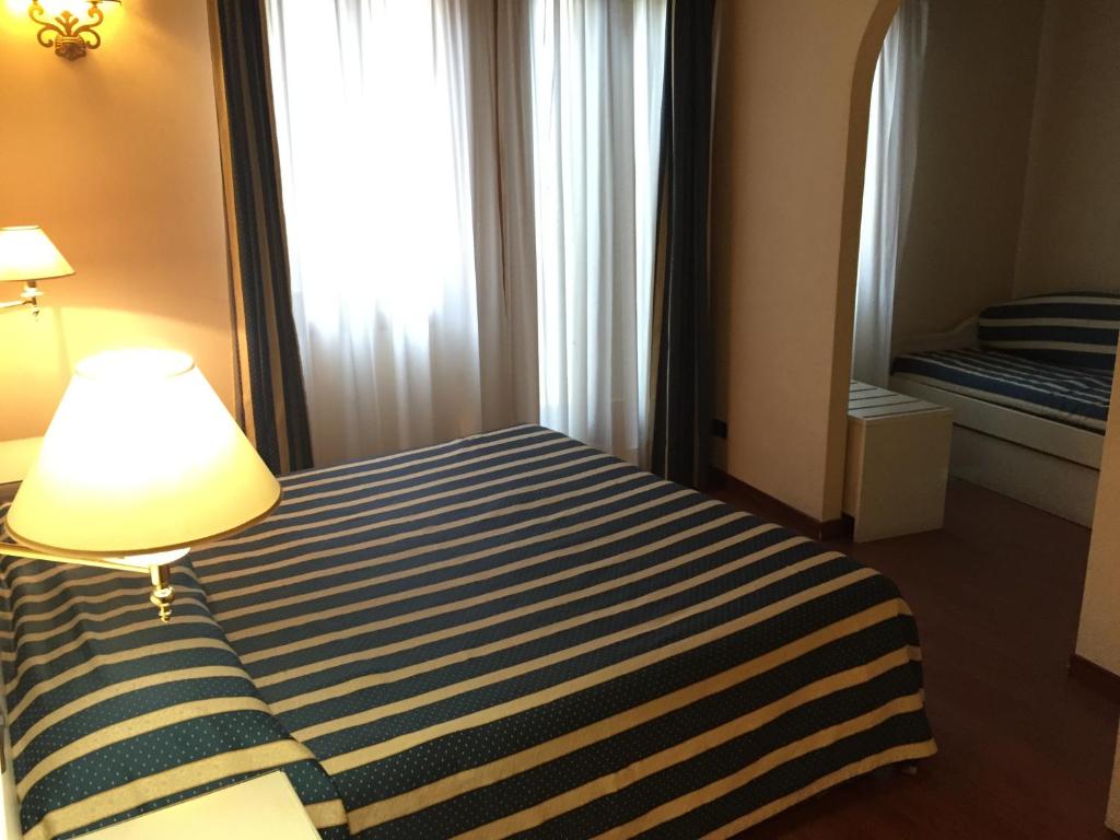 Postel nebo postele na pokoji v ubytování Venice Resorts Guest House