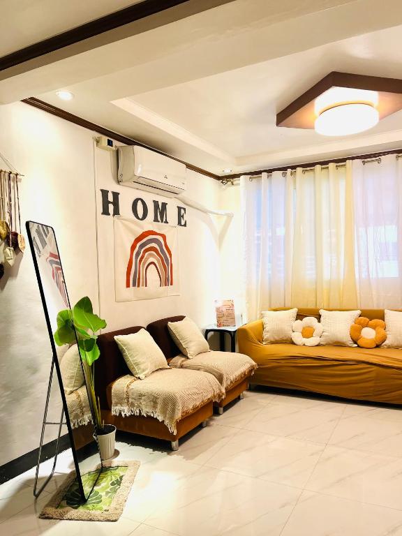 a living room with two beds and a couch at Calapan Transient House Xevera in Calapan