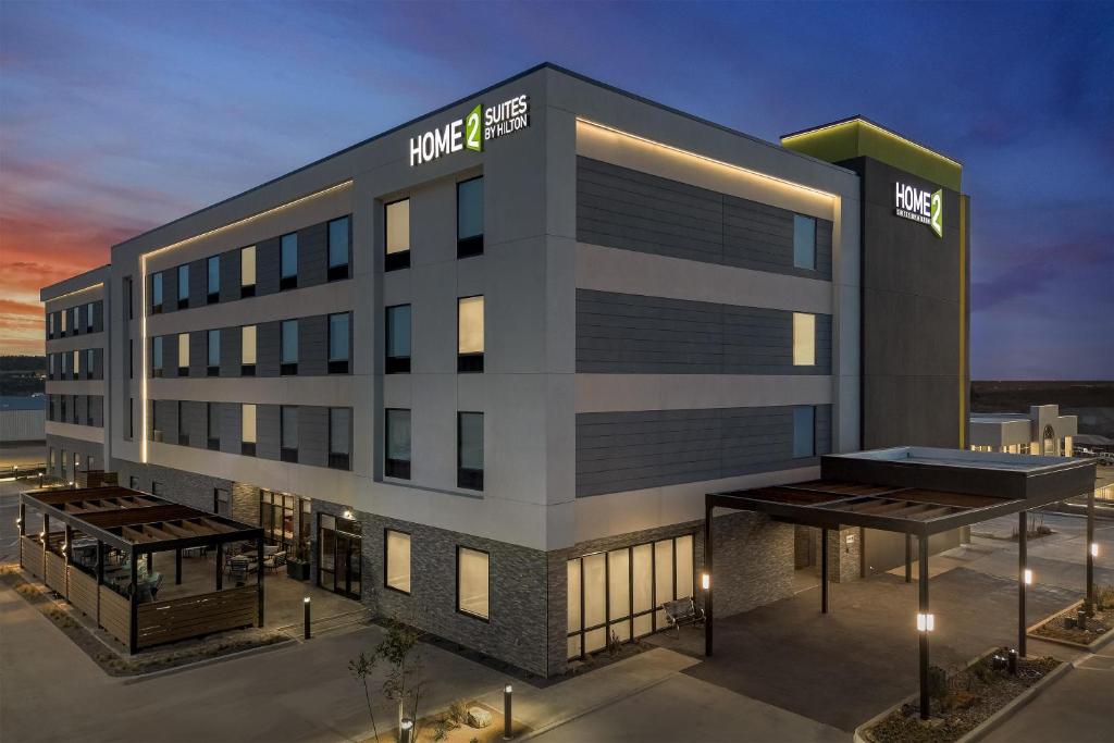 a rendering of a hotel building at night at Home2 Suites By Hilton Big Spring in Big Spring