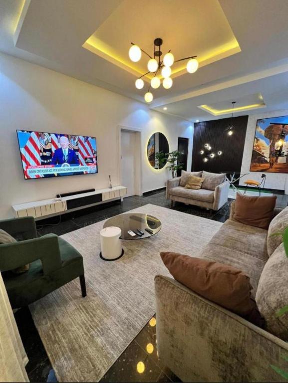 a living room with a couch and a tv at Paradise View Apartment in Gatunga
