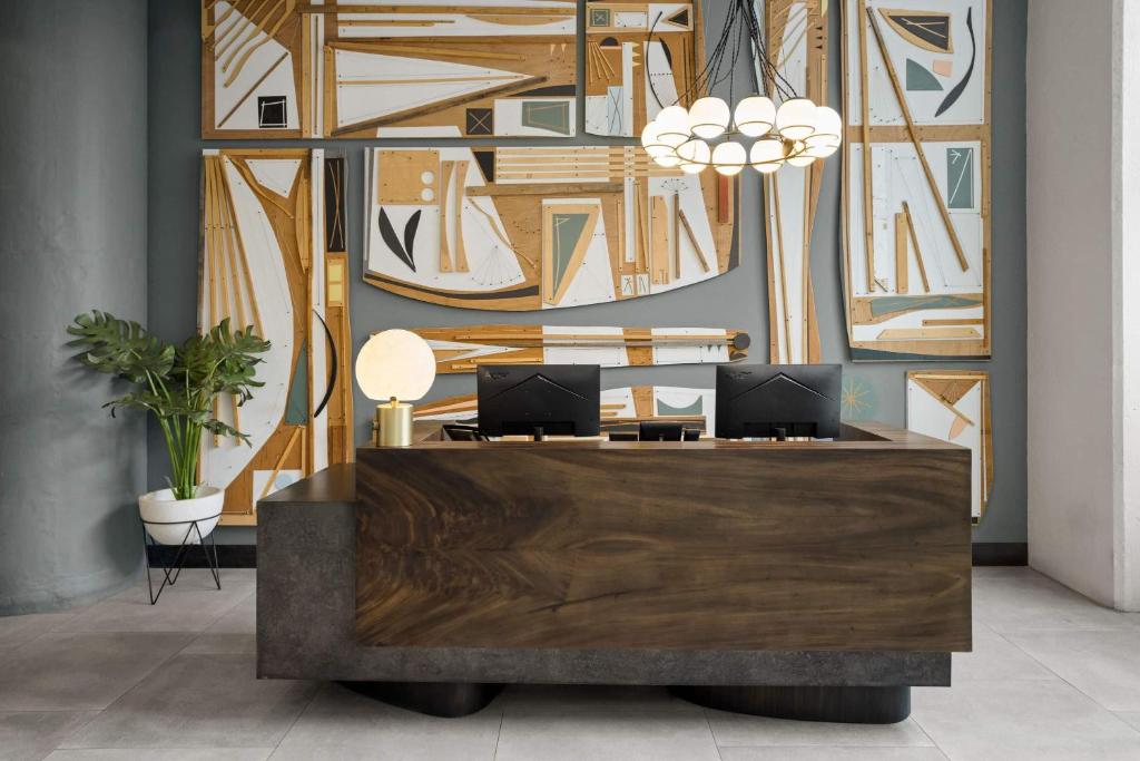 a lobby with a desk with two computers on it at The Heid Lofts by Reside, a Wyndham Residence in Philadelphia