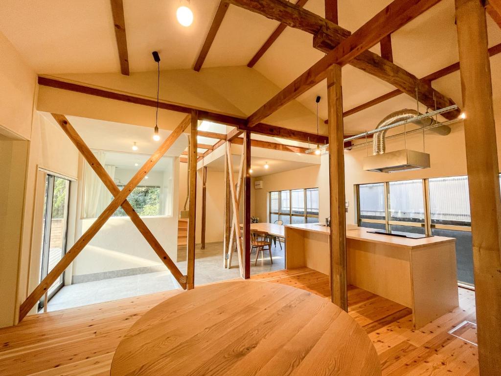 a kitchen and dining room with a wooden table at Beppu TOJIHAUS 001 2min walk to Shibaseki Onsen in Beppu