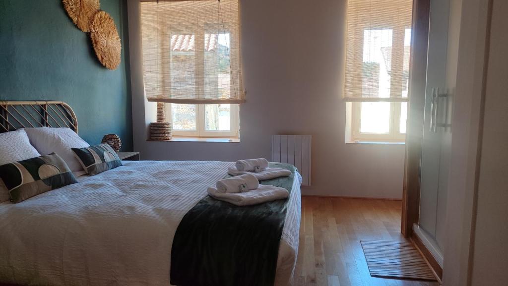 a bedroom with a bed with two teddy bears on it at Ma Bégude in Rieutord