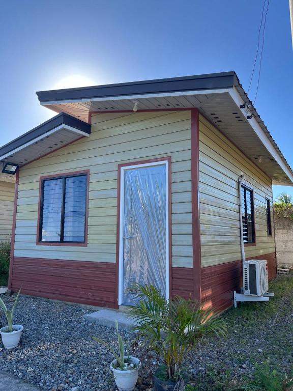 a small house with a door on the side of it at Blueznest in Babag Island