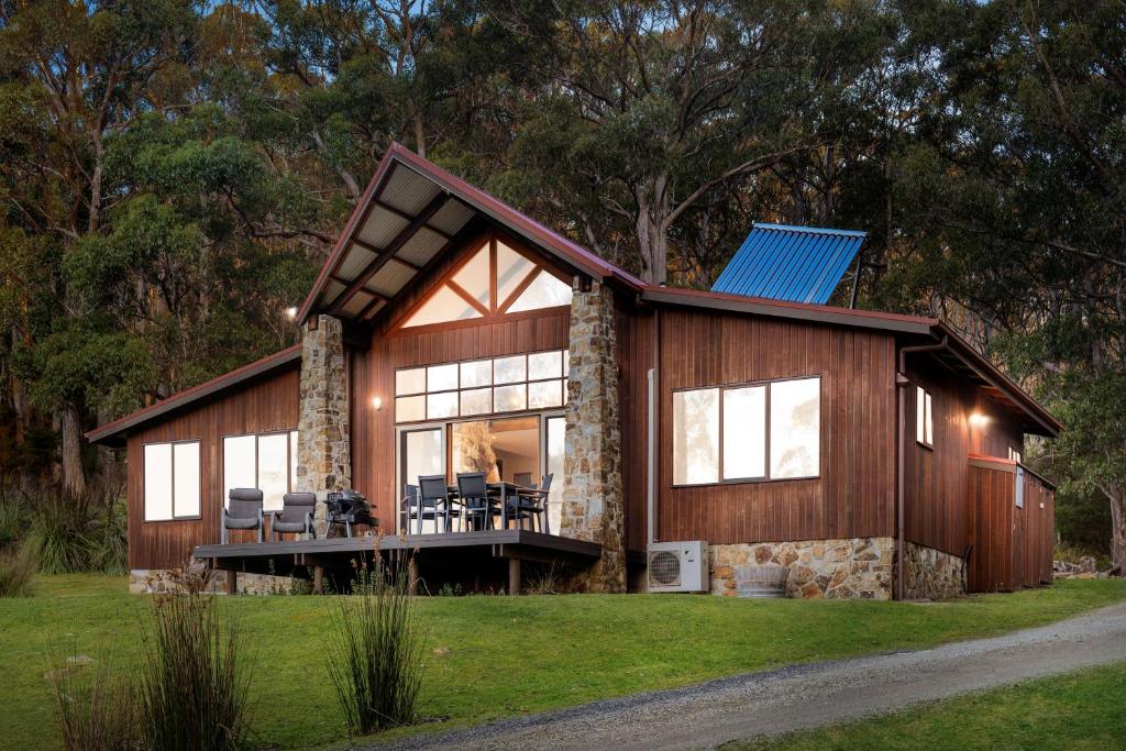 a home with a gambrel roof and a house with windows at Adventure Bay Retreat Bruny Island in Adventure Bay
