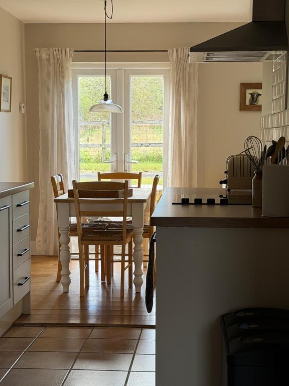 a kitchen and dining room with a table and chairs at The Old Tearooms in Rural Northumberland in Edlingham