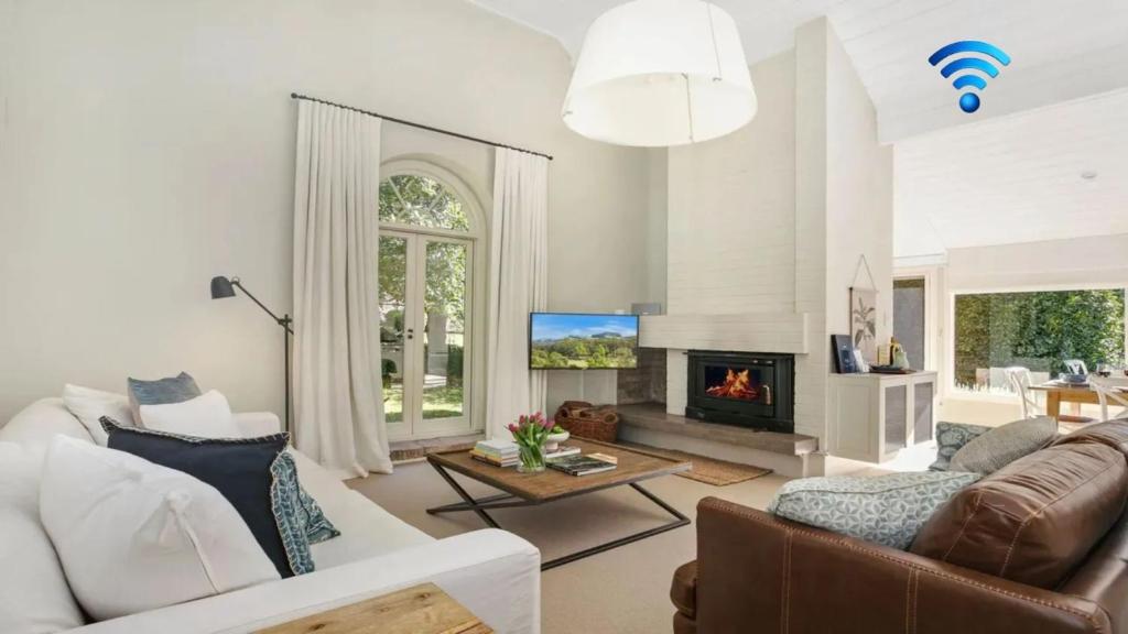 a living room with a couch and a fireplace at Protestant Hall in Wildes Meadow