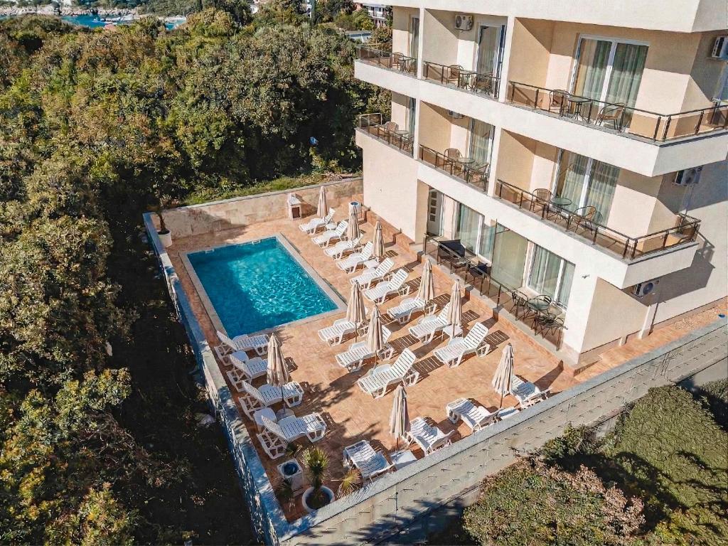 an aerial view of a hotel with a swimming pool and chairs at ARA Lux Apartments in Utjeha