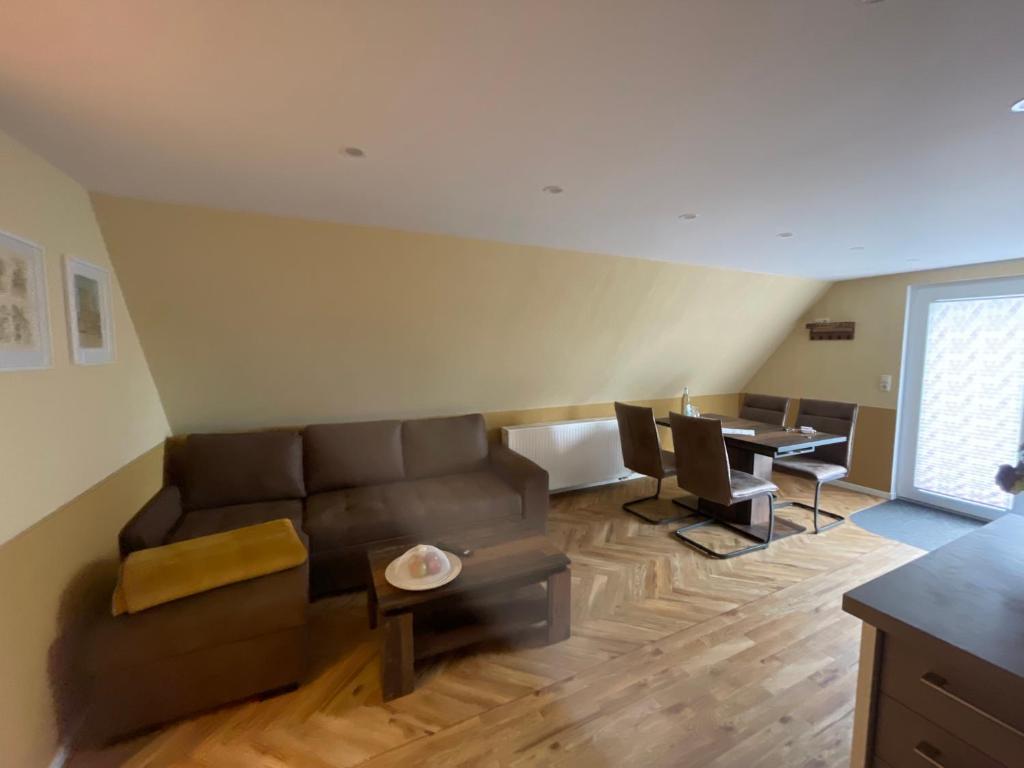 a living room with a couch and a table at Heinrich Heine in Tangermünde