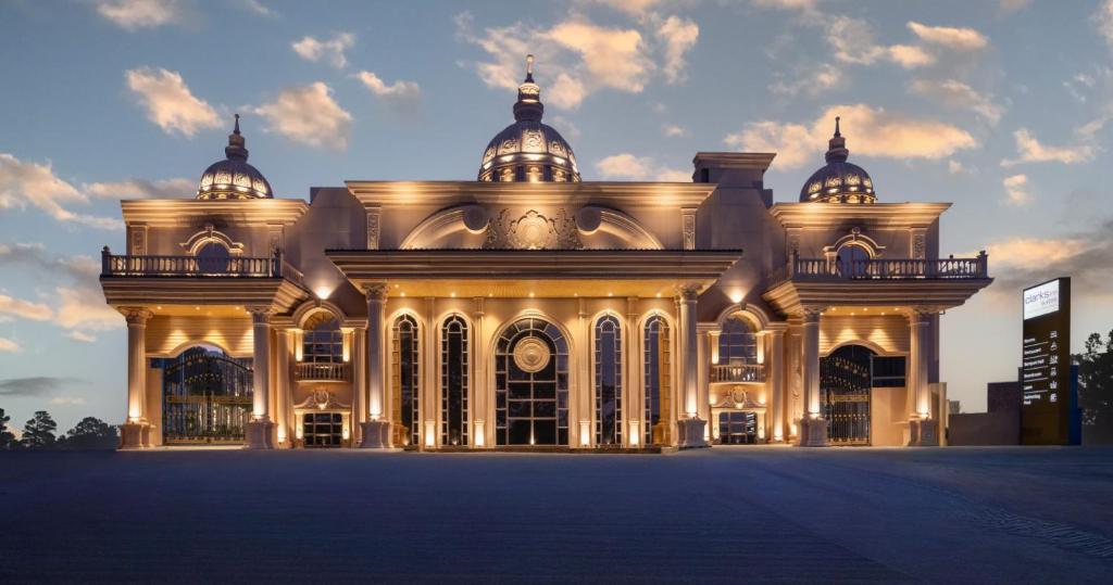 a large building with lights on the front of it at Clarks Inn Suites Dhanbad in Dhanbād