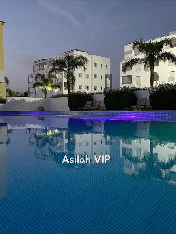 a view of a swimming pool in front of a building at Asilah VIP - Sea view & Swimming Pools - Garage Private in Asilah