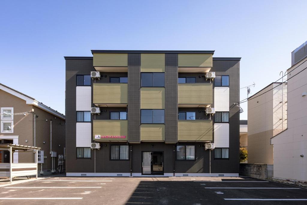 an empty parking lot in front of a building at HARUSAKU Omachi in Asahikawa
