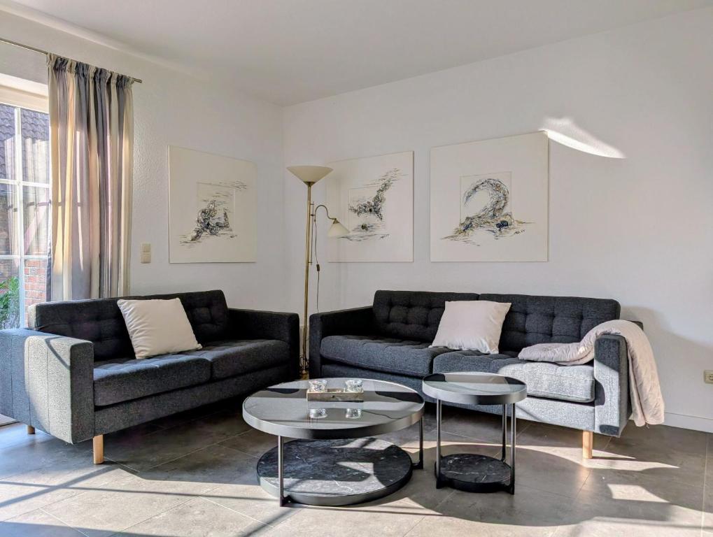 a living room with two couches and a table at Ferienhaus Lükko in Greetsiel