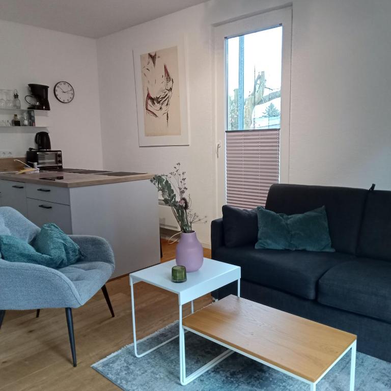 a living room with a couch and a table at Fischstübchen Neeberg Fewo 2 - Achterwasser in Krummin