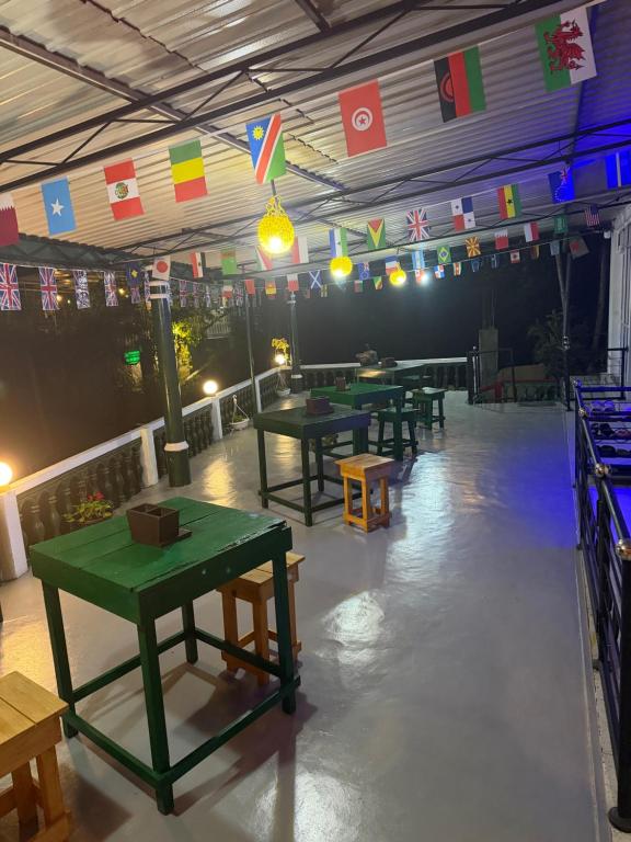 a group of tables in a room with flags at Okan Rock Residence in Ella