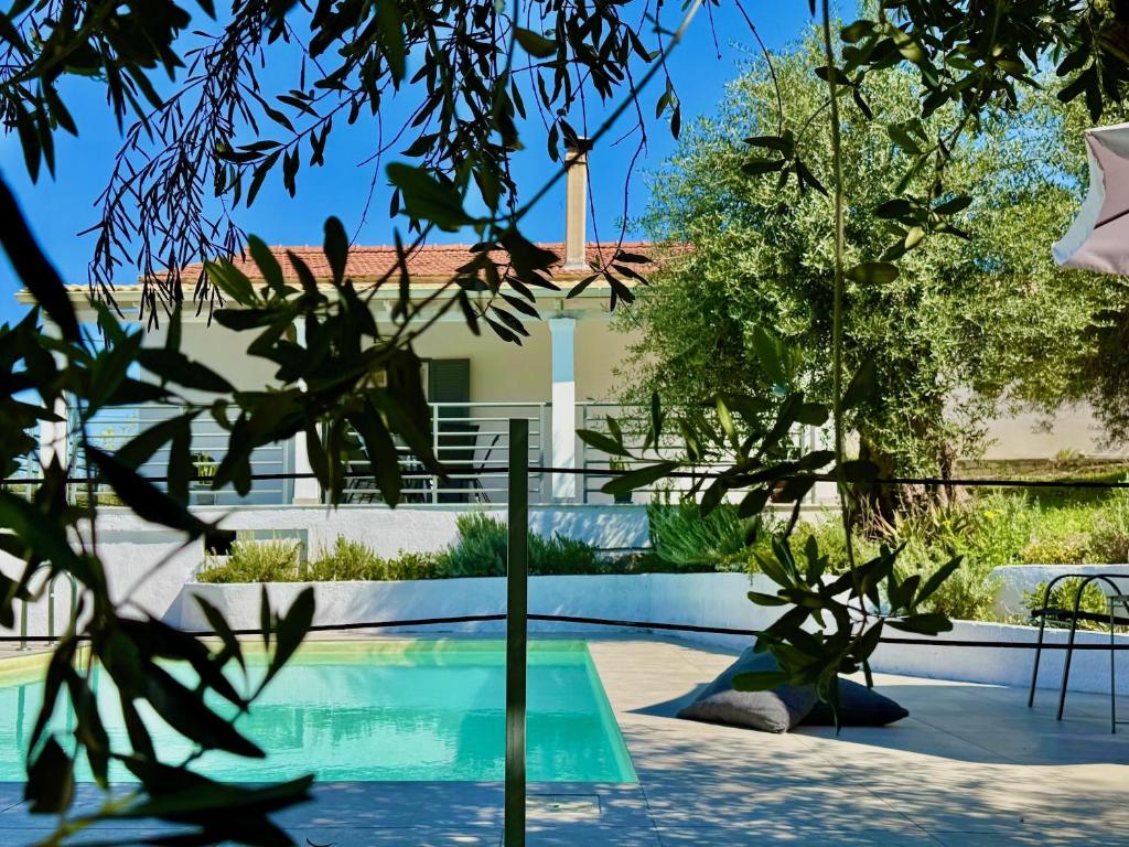a house with a swimming pool and trees at Elea Boutique Villa with private pool by DadoVillas in Acharavi