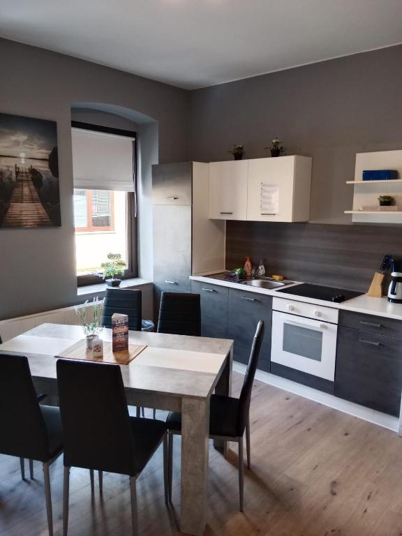 a kitchen and dining room with a table and chairs at Flensburg City 6 1 in Flensburg