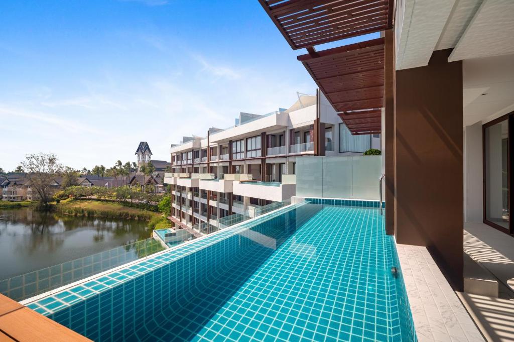 a swimming pool on the side of a building at Angsana Oceanview Residences Building 2 in Laguna by Banyan Living in Bang Tao Beach