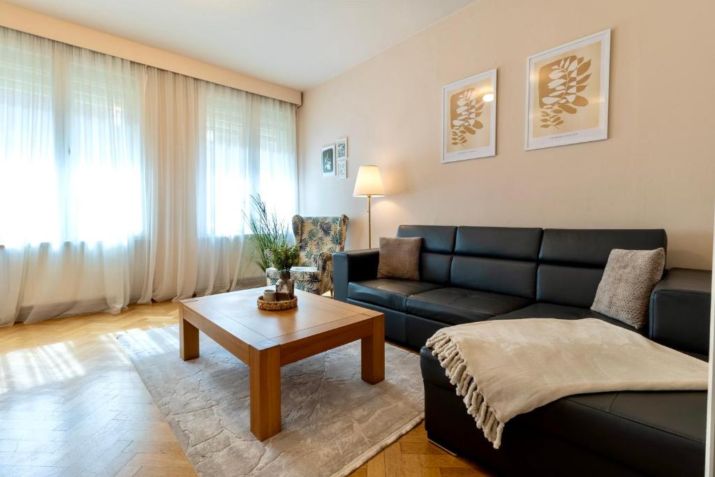a living room with a couch and a table at Schiller Apartment - Old Town in Sibiu