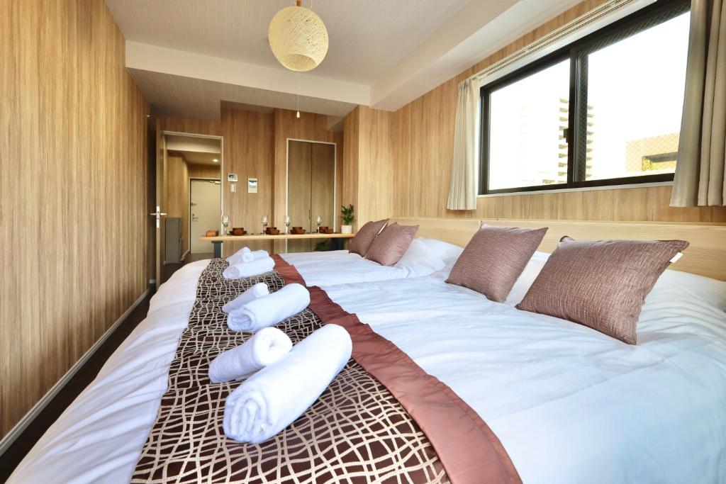 a large bed in a room with pillows on it at Kyo-wa Hotel Oshiage in Tokyo