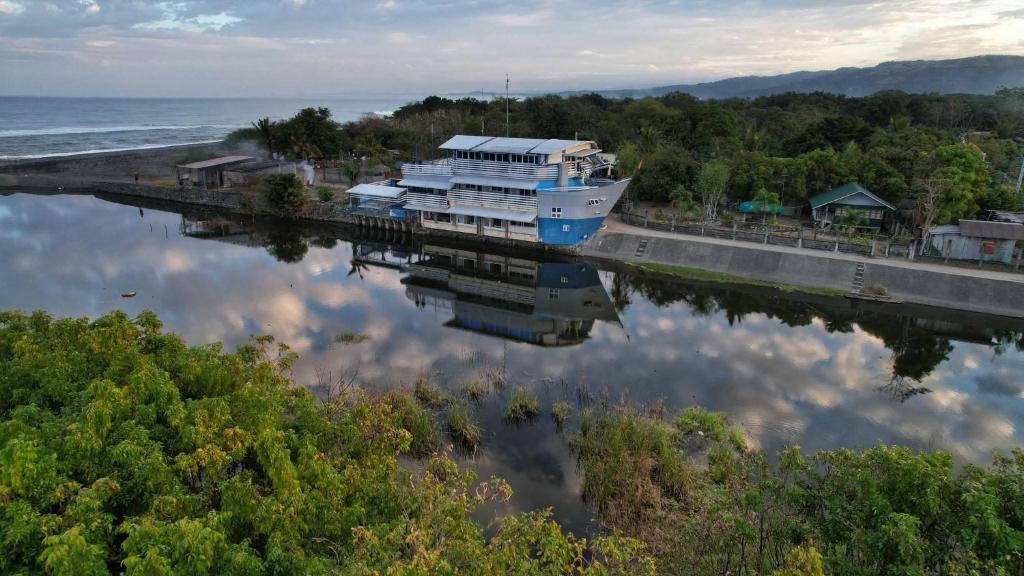 a boat is docked at a dock on the water at Hotel Tagudan Kubo Corporation in Tagudin