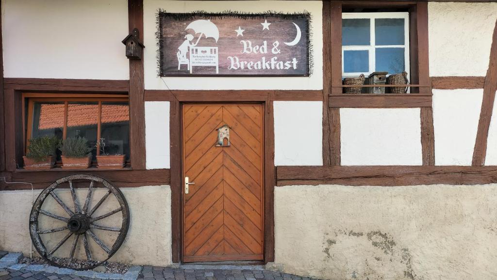a dog sitting on the door of a building at B&B Herberg im Eichberg in Dettighofen