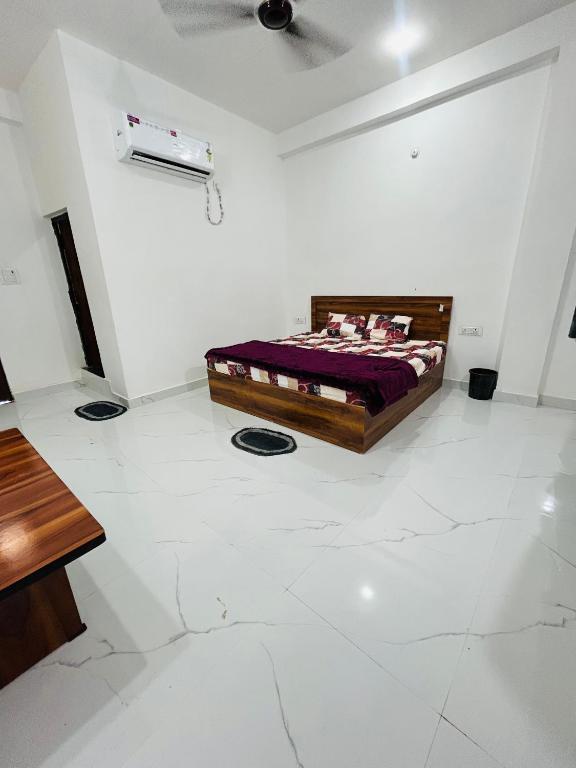 a bedroom with a bed in a white room at Skyline Hotel & Banquet in Rewa