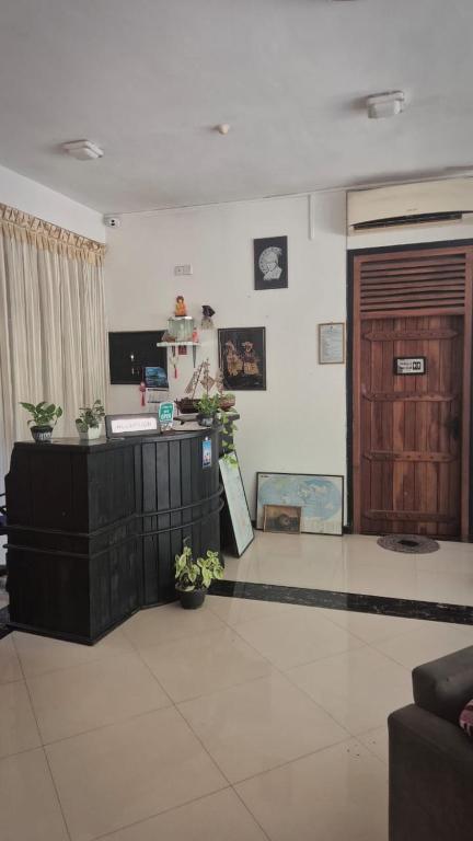a living room with a counter and a door at Pearl City Resort in Tissamaharama