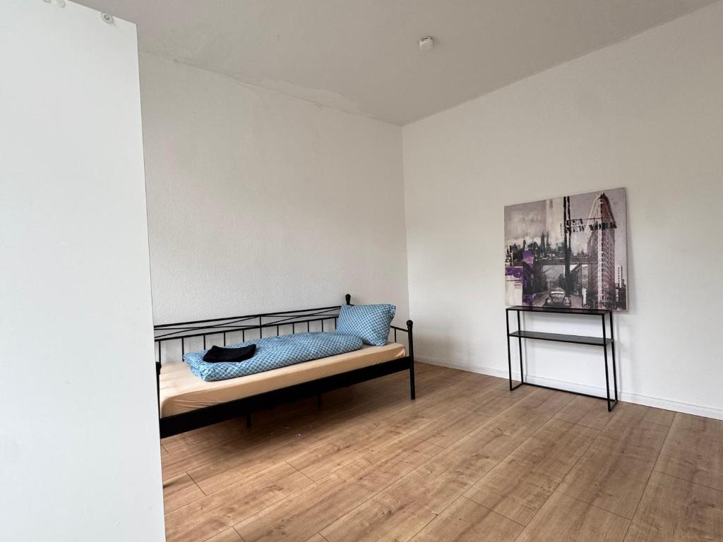 a room with a bed with a blue pillow on it at Platin Appartement in Wuppertal