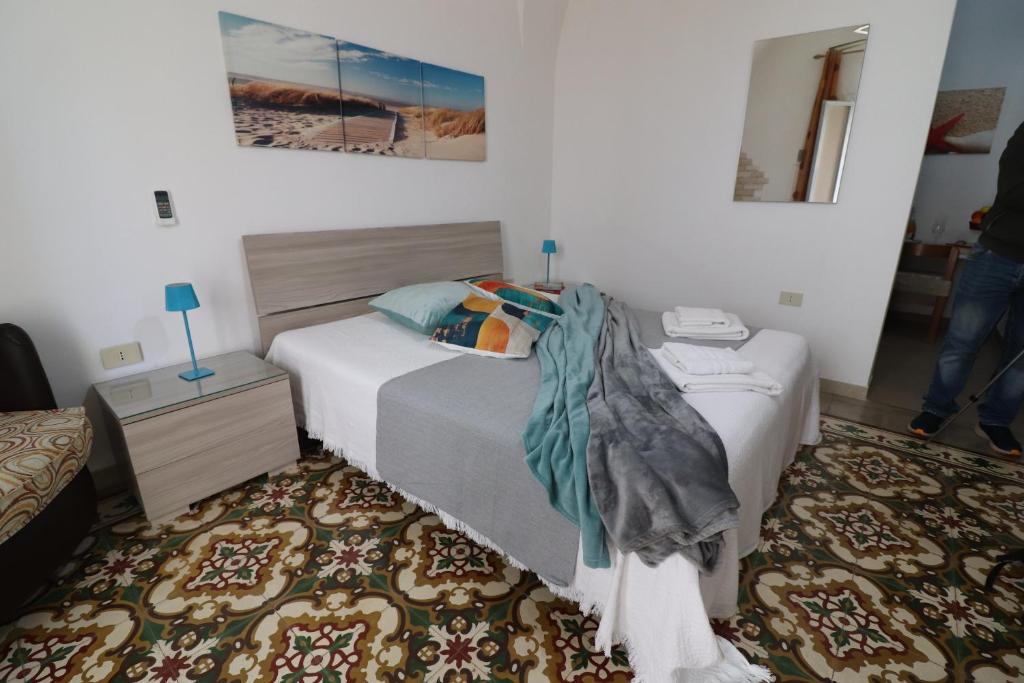 a bedroom with a bed and a rug at Kyma's House in Otranto in Otranto