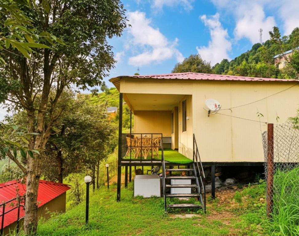 a small house with a staircase leading up to it at 7 Hills Resort Kanatal in Kanatal