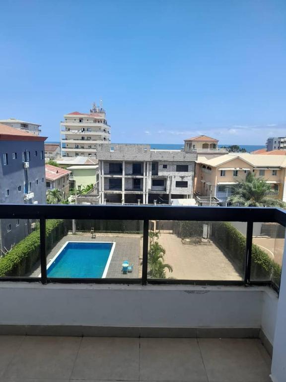 a balcony with a view of a swimming pool at Appart Congo-Warf- vue mer in Pointe-Noire