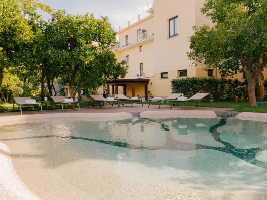 a swimming pool in front of a building at Unconventional Sorrento Coast in Sant'Agnello